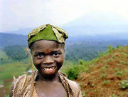 A boy wears a hat made of leaves in the countryside near Jomba, Democratic Republic of the Congo